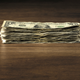 stack of dollar bills on the table